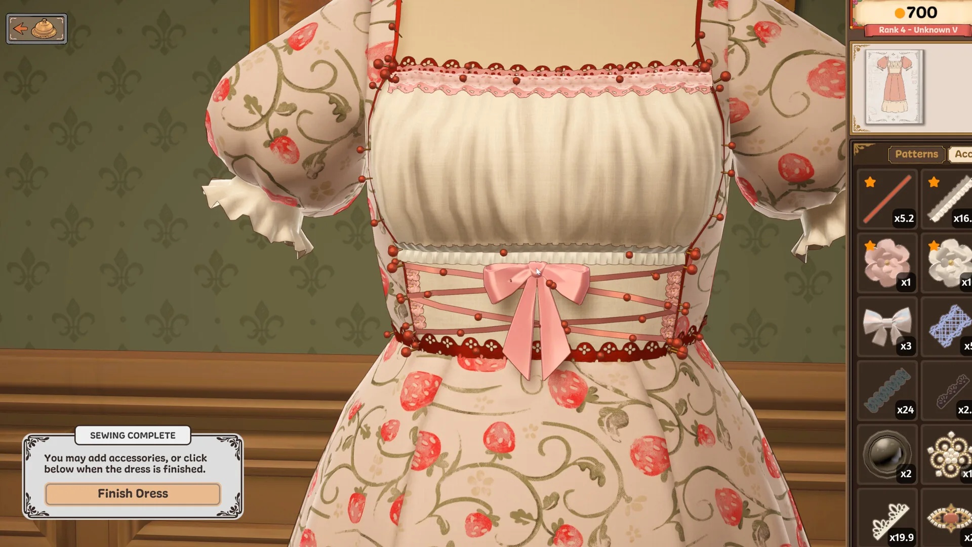 Strawberry-print bodice with pink bow and lace beside the Finish Dress control